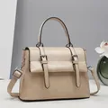Detailed view of beige vintage satchel showing leather texture and buckle straps - Khaki