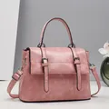 Macro shot of pink marble texture faux leather with silver buckle detail on handbag - Pink