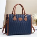 Large blue and brown color-block leather tote bag with gold hardware and top handles - L32 W12 H25 / Blue