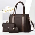Detailed set of brown pebble leather tote, envelope wallet, and key pouch on white stand - Coffee