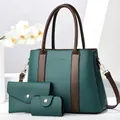 Detailed view of the three-piece handbag set featuring litchi grain texture and gold hardware - Green