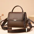 Classic dark brown leather handbag for women featuring a wide woven shoulder strap - Small / Coffee