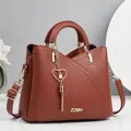 Brick red lychee leather handbag with ZZMY logo, metal chain and pearl heart pendant - Length 23 Height 19 Width 11 / Earthy Yellow