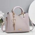 Detail of lavender litchi leather handbag with heart pendant and gold ZZMY branding - Length 23 Height 19 Width 11 / Gray