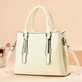 Elegant cream beige faux leather tote bag with sturdy handles and adjustable shoulder strap - Vintage Texture Off-white