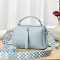 Detail of light blue lychee pattern handbag with stylish wide woven geometric shoulder strap - 24cmx10cmx14cm / Sky Blue