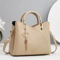Beige lychee grain leather handbag with heart tassel pendant and adjustable strap - Length 23 Height 19 Width 11 / Light Khaki