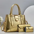 Golden crocodile embossed three-piece handbag set with large tote and envelope clutch - Gold