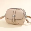 Chic beige crossbody round bag with triple zipper layers and silver ring buckle detail - Khaki