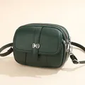 Deep green textured leather crossbody bag with three zipper compartments and silver buckle - Green