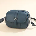 Dark teal crossbody bag with lychee texture, three zip pockets and silver bow detail - Blue