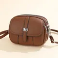 Brown lychee leather small crossbody bag with three zippers and silver bow buckle - Dark Brown