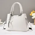 Elegant white pebbled leather tote bag with silver star charm and dual carrying straps - White