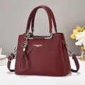 Burgundy litchi leather tote bag with silver hardware and star charm accessory - Red