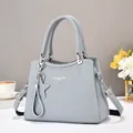 Close-up of foggy blue tote bag with lychee grain texture and star tassel charm - Fog Blue