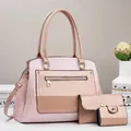 Detailed close-up of pink faux leather bag set with crocodile texture and gold hardware - Pink