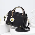 Minimalist black faux leather handbag with white stitching and round metal handle - Black