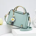 Mint green square handbag with gold handle, daisy pendant, and faux leather texture - Light Green