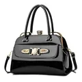Elegant black patent leather handbag with gold hardware and sparkling diamond accents - Black