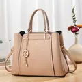 Minimalist beige pebble leather tote bag with elegant star charm and adjustable strap - Khaki