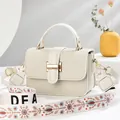 Fashionable beige crossbody bag with bohemian wide strap and textured fabric finish - White