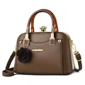 Dark brown leather shell bag with amber resin handles and a rose charm accessory - Brown