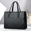 Black geometric patchwork tote bag with gold hardware for business and casual wear - Black