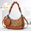 Brown monogram crescent underarm bag with pleated handle and mini round coin purse charm - Earthy Yellow