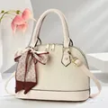 Elegant beige pleated shell handbag with decorative silk scarf and gold hardware accents - White