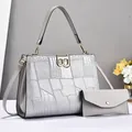 Detail of silver crocodile pattern patchwork bag with golden metal B-buckle and envelope pouch - Silver