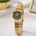 Detail view of gold steel band watch with emerald green dial on a white display tray - Gold Band Green Dial