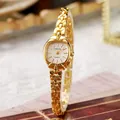 Vintage gold quartz bracelet watch for women with tonneau dial on a retro book background - Radiant Texture Style / Gold Band With White Dial