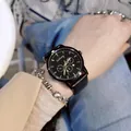 Stylish large dial watch with black leather strap and gold markers worn on wrist - Black