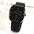 Black square quartz watch with silicone strap and rose gold accents on white background - Black