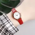 Detail of red leather strap watch with rose gold case and date window on white dial - Red