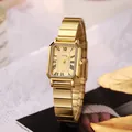 Close-up of a rectangular gold watch with champagne sunburst dial and Roman numerals - Gold Band Gold Dial