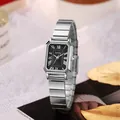 Detail of silver rectangular quartz watch with black dial and Roman numerals on soft fabric - Silver Strap Black Dial