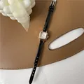 Vintage quadratische Quarzuhr in Roségold mit schwarzem Lederarmband auf Braun - Schwarz