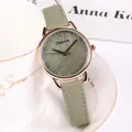 Detailed shot of a rose gold watch with green dial hung on a stylish white coffee cup - Green