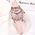 Close-up of pink leather strap and rose gold quartz watch dial for women - Pink