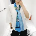 Detailed texture of blue silk scarf featuring horse carriage motifs and geometric patterns - Sky Blue