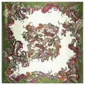 Close-up detail of green paisley silk scarf texture with floral patterns on silk fabric - Green
