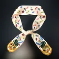 Detail of silk twilly scarf featuring artistic tiger head and floral pattern with care label - Cream Tiger Flower (C141-3)