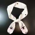 Close-up of cream skinny scarf with pink cartoon sheep and star patterns on black silk - Cream Sheep Stars (C141-10)