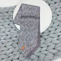 Macro shot of 100% silk tie featuring gray bird patterns and purple geometric inner lining - Gray
