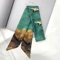 Detail of green and gold twilly silk scarf with crane print on white background - 95cm / Crane Mountain Art Style (C145-17)