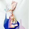 Detail of Virgo constellation silk scarf with floral patterns and pastel color stripes - Virgo
