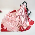 90cm floral silk scarf with pink peach blossoms draped over a dark green handbag - 90cmx90cm / Red