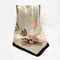 Champagne gold satin scarf with tulip floral print hanging on a dark wooden rack - Coffee Edge