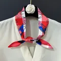 Silk neck scarf with floral chain print worn on white shirt against a dark background - 88cm / Red Chain Style (C157-2)